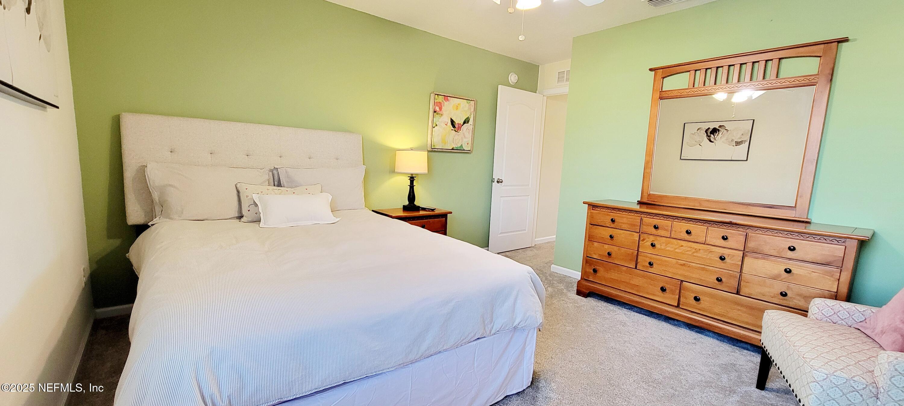 82 Whitland Way St. Augustine, FL 32086 - Photo 14 of 24 a bedroom with a bed and a dresser