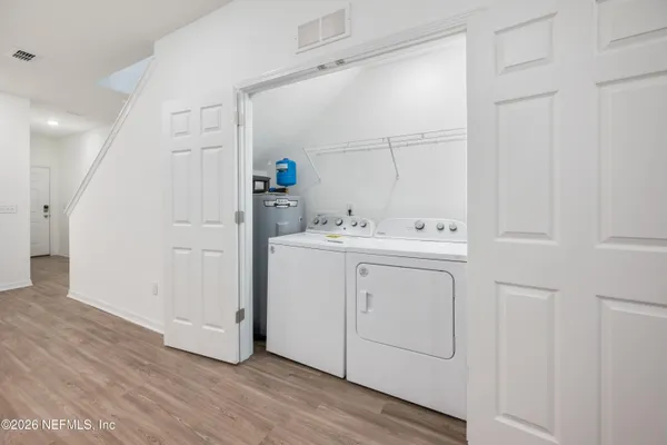 a utility room with cabinets washer and dryer