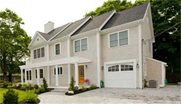 a view of a white house with a small yard and large tree