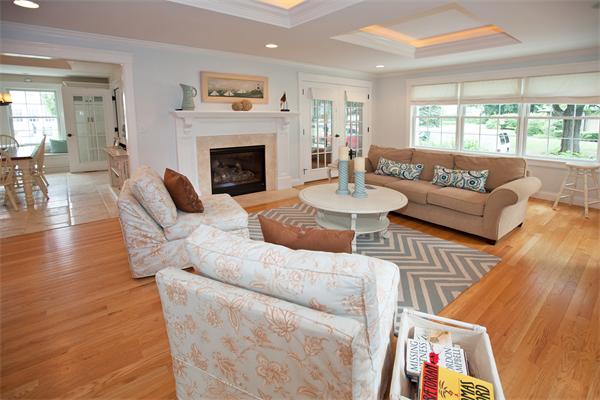 20 Grasshopper Lane Scituate, MA 02066 - Photo 16 of 30 a living room with furniture a fireplace a large window and a flat screen tv