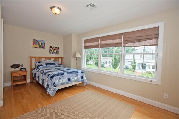 20 Grasshopper Lane Scituate, MA 02066 - Photo 22 of 30 a bedroom with a bed and wooden floor