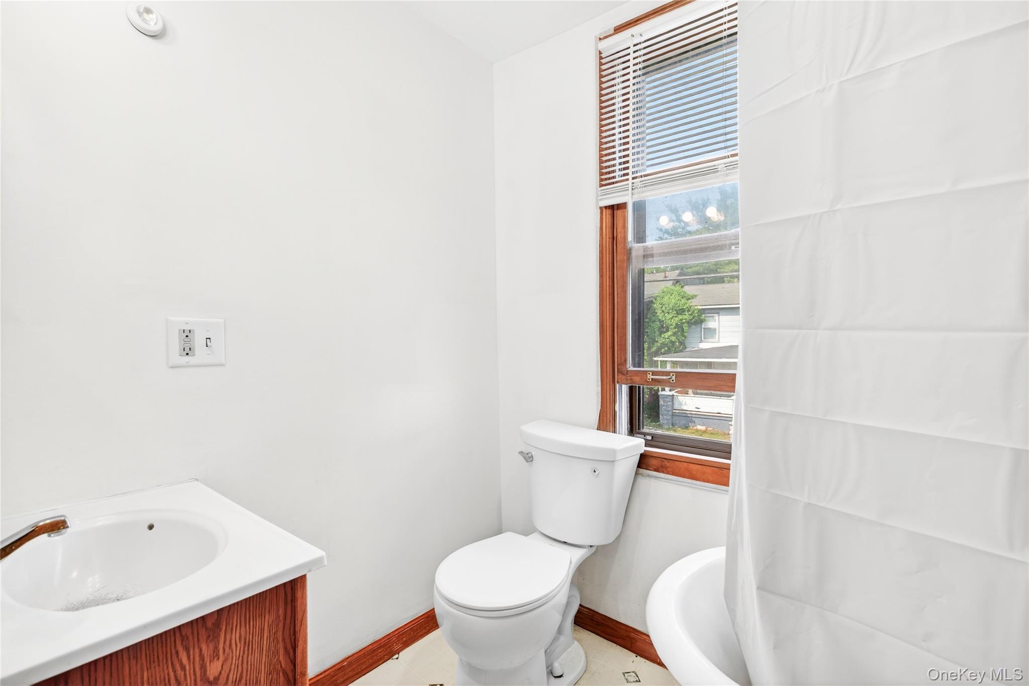 131 Front Street Port Jervis, NY 12771 - Photo 27 of 35 Bathroom featuring baseboards, toilet, and vanity