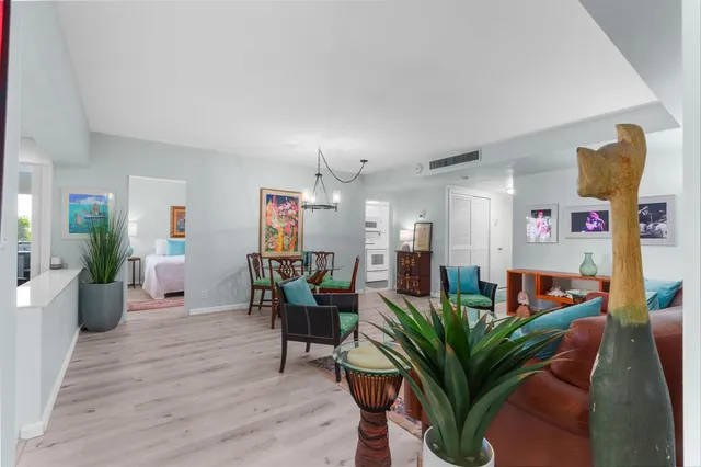 a living room with furniture potted plant and couches