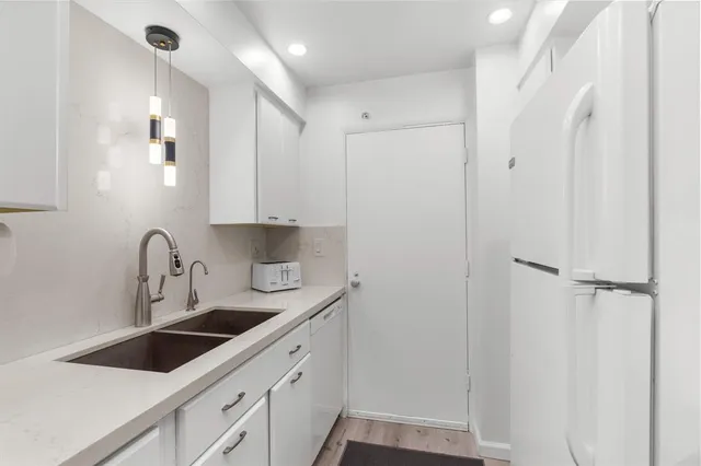 a kitchen with a sink and cabinets