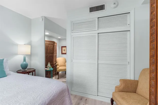 a bedroom with a bed and a lamp