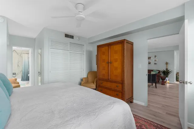 a bedroom with a bed and wooden floor