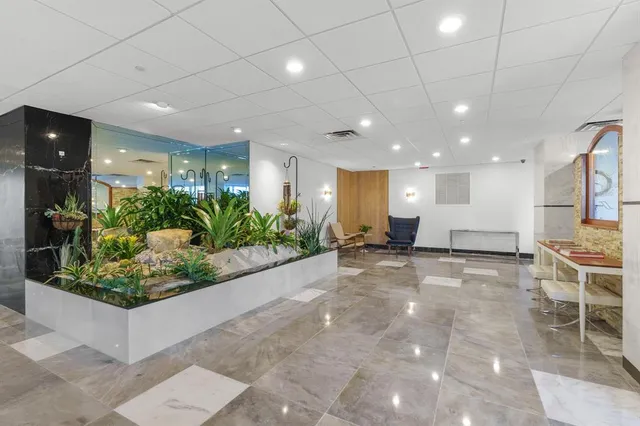 a view of a lobby with furniture and potted plants