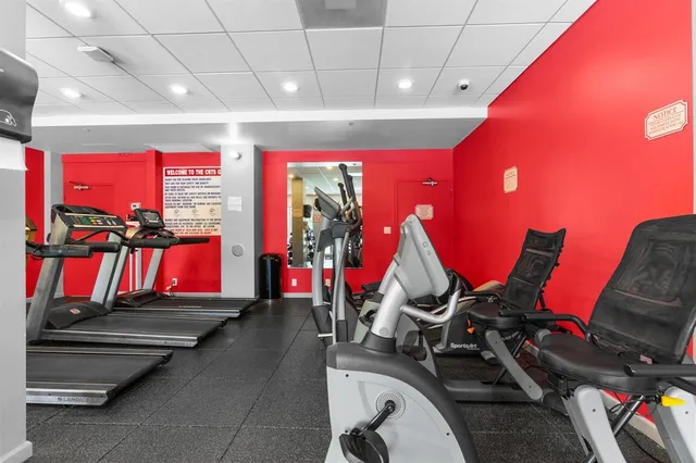 a room with gym equipment and air hockey table