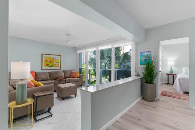 a living room with furniture and large windows