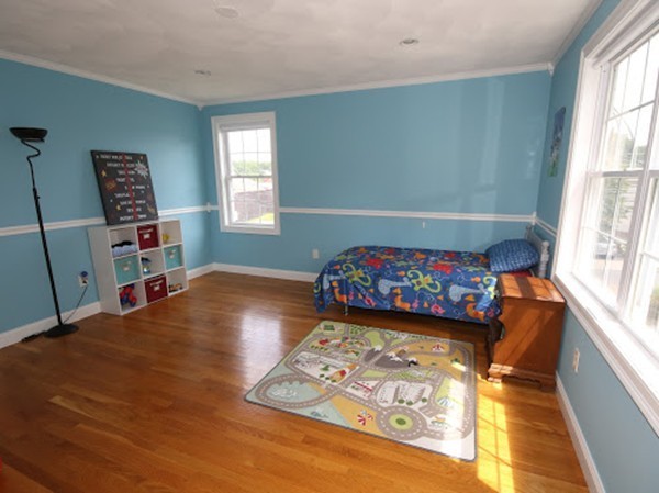 5 Melvin Street, Unit B Wakefield, MA 01880 - Photo 23 of 28 a bedroom with a bed and wooden floor