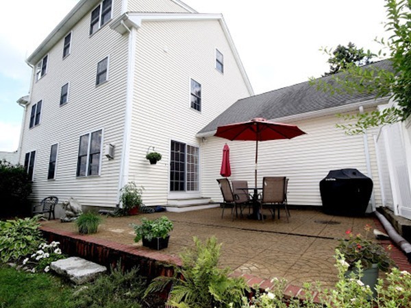 5 Melvin Street, Unit B Wakefield, MA 01880 - Photo 28 of 28 a view of a patio with table and chairs under an umbrella