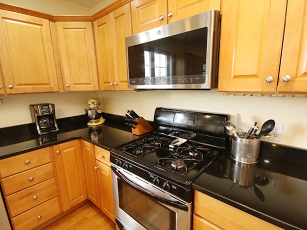 5 Melvin Street, Unit B Wakefield, MA 01880 - Photo 8 of 28 a kitchen with a sink a stove and cabinets