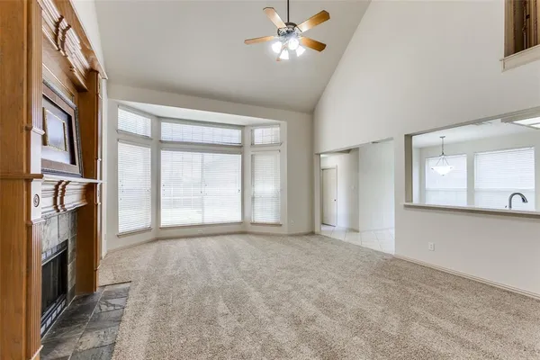 a view of empty room with window and fireplace