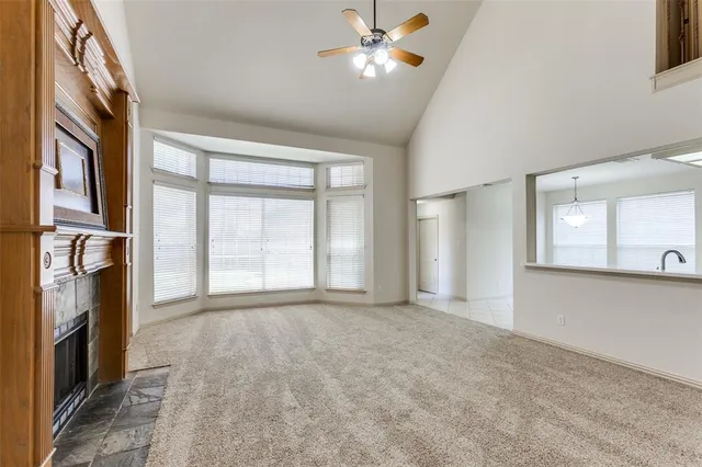 a view of empty room with window and fireplace