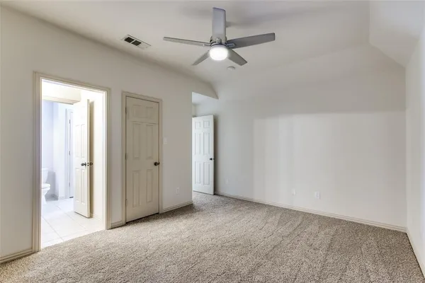 a view of a room with a ceiling fan and a bathroom