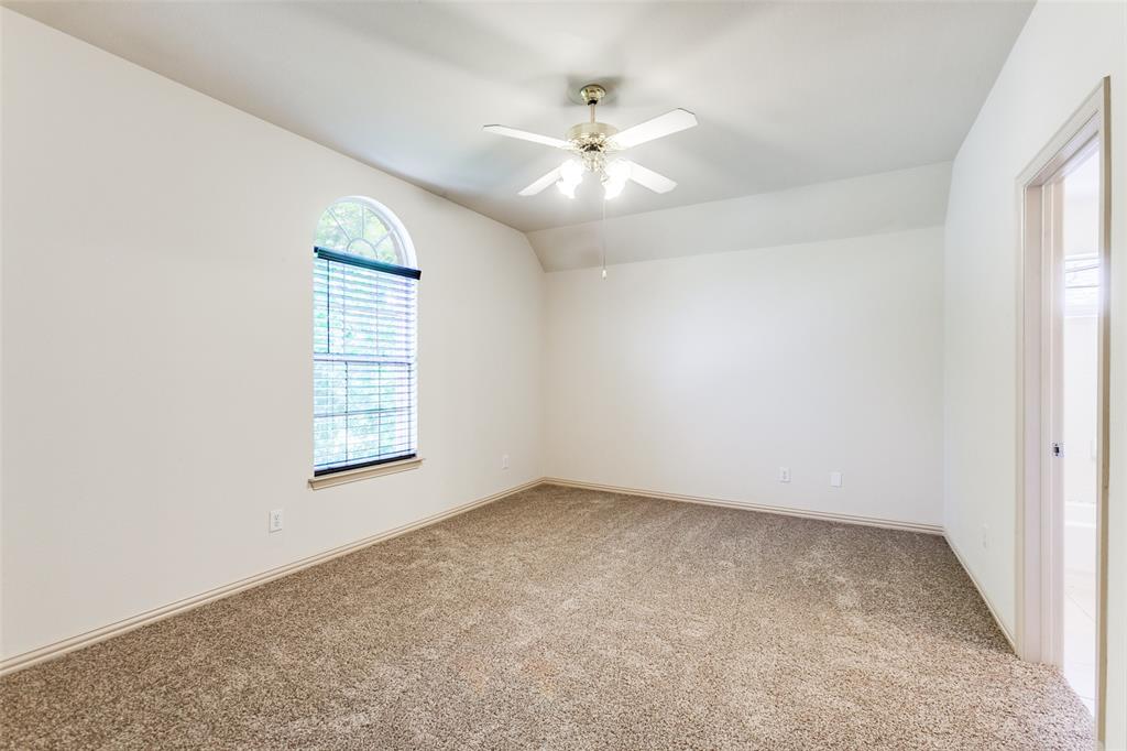 4400 Orchard Gate Lane Plano, TX 75024 - Photo 10 of 12 an empty room with windows and chandelier fan