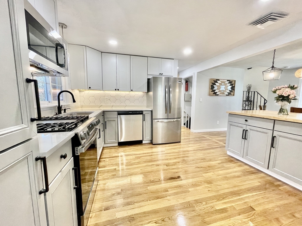 17 Brentwood Road Sudbury, MA 01776 - Photo 12 of 34 a kitchen with stainless steel appliances granite countertop a refrigerator and a stove top oven