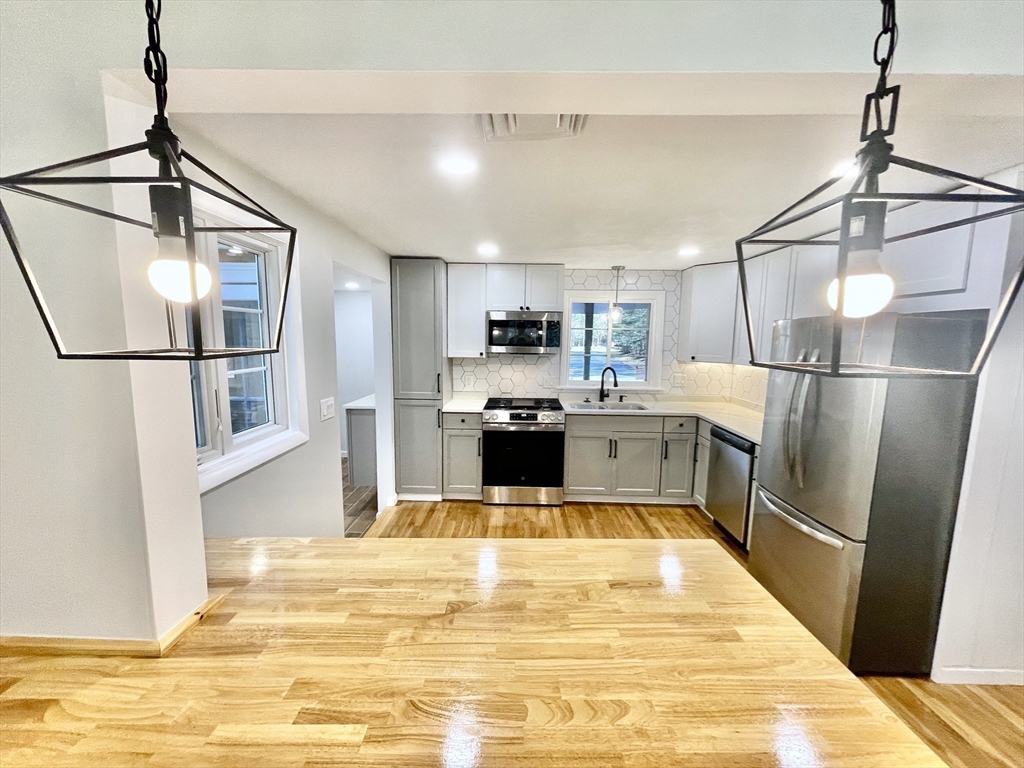 17 Brentwood Road Sudbury, MA 01776 - Photo 14 of 34 a kitchen with stainless steel appliances granite countertop a refrigerator and a sink