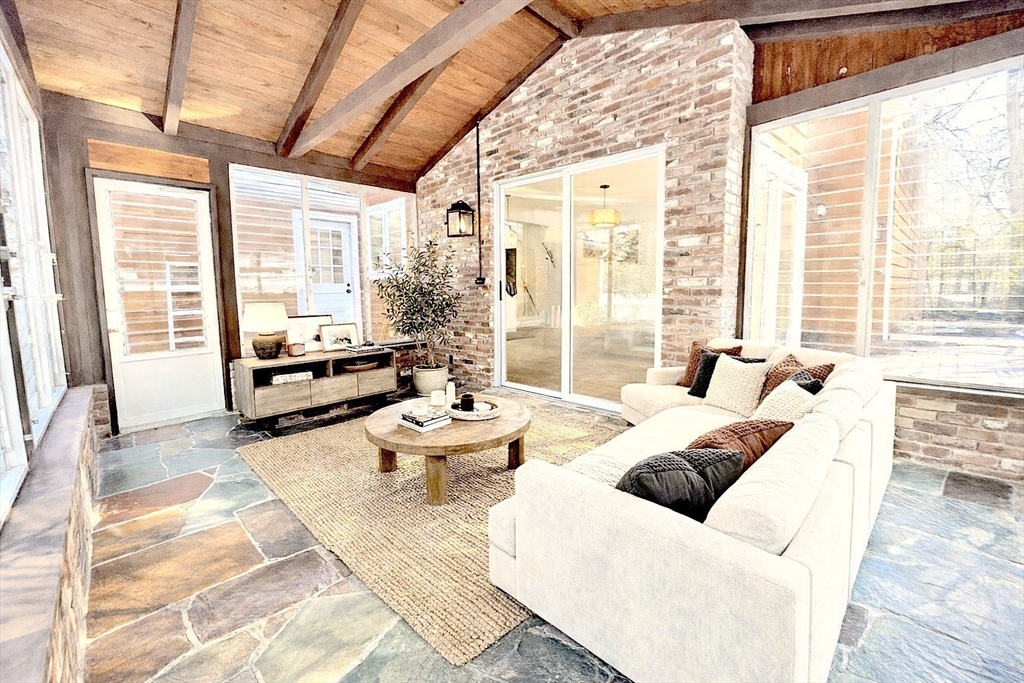 17 Brentwood Road Sudbury, MA 01776 - Photo 18 of 34 a living room with furniture and floor to ceiling windows