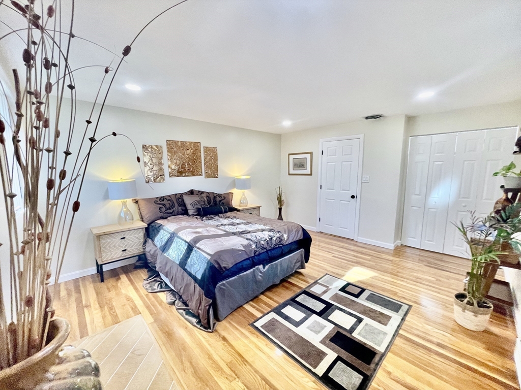 17 Brentwood Road Sudbury, MA 01776 - Photo 22 of 34 a spacious bedroom with a bed and a table in it