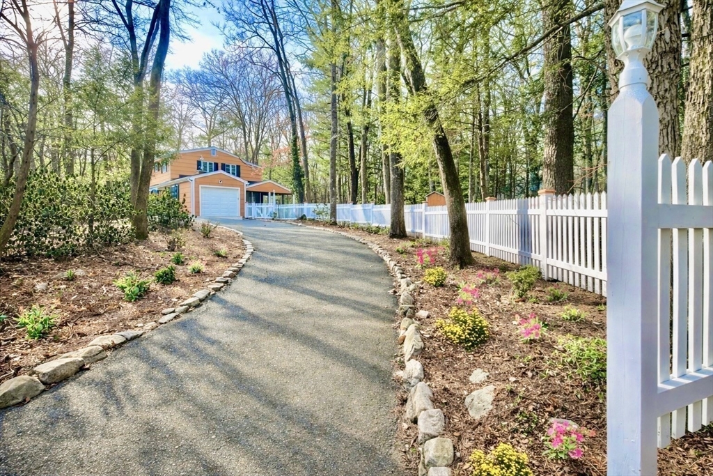 17 Brentwood Road Sudbury, MA 01776 - Photo 34 of 34 a front view of a house with a yard and fountain