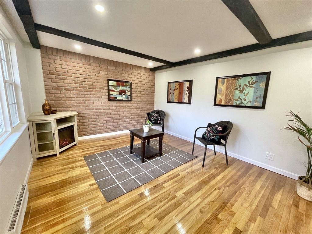 17 Brentwood Road Sudbury, MA 01776 - Photo 6 of 34 a living room with wooden floor and furniture