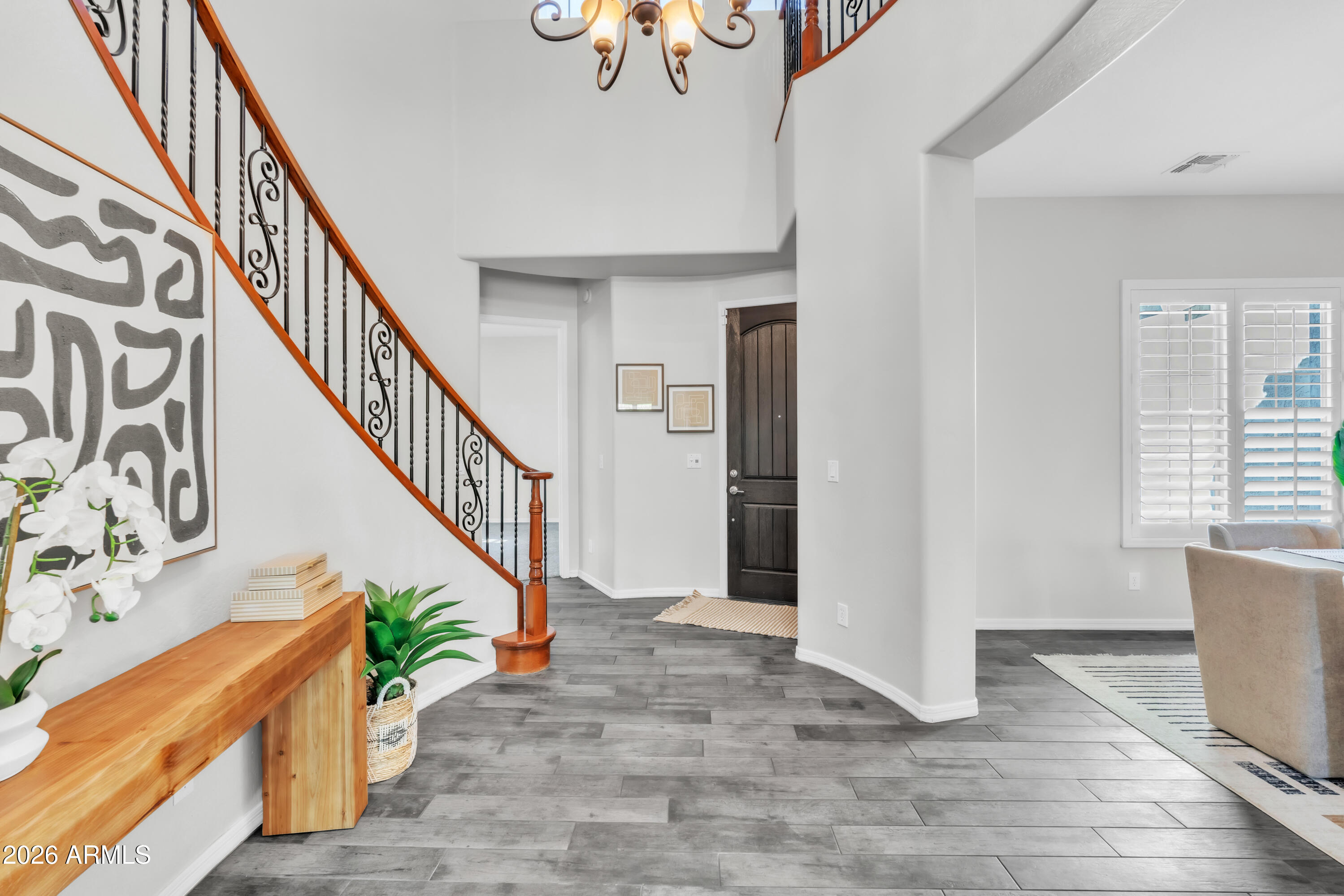 1615 West Red Fox Road Phoenix, AZ 85085 - Photo 13 of 64 a view of entryway with wooden floor and stairs