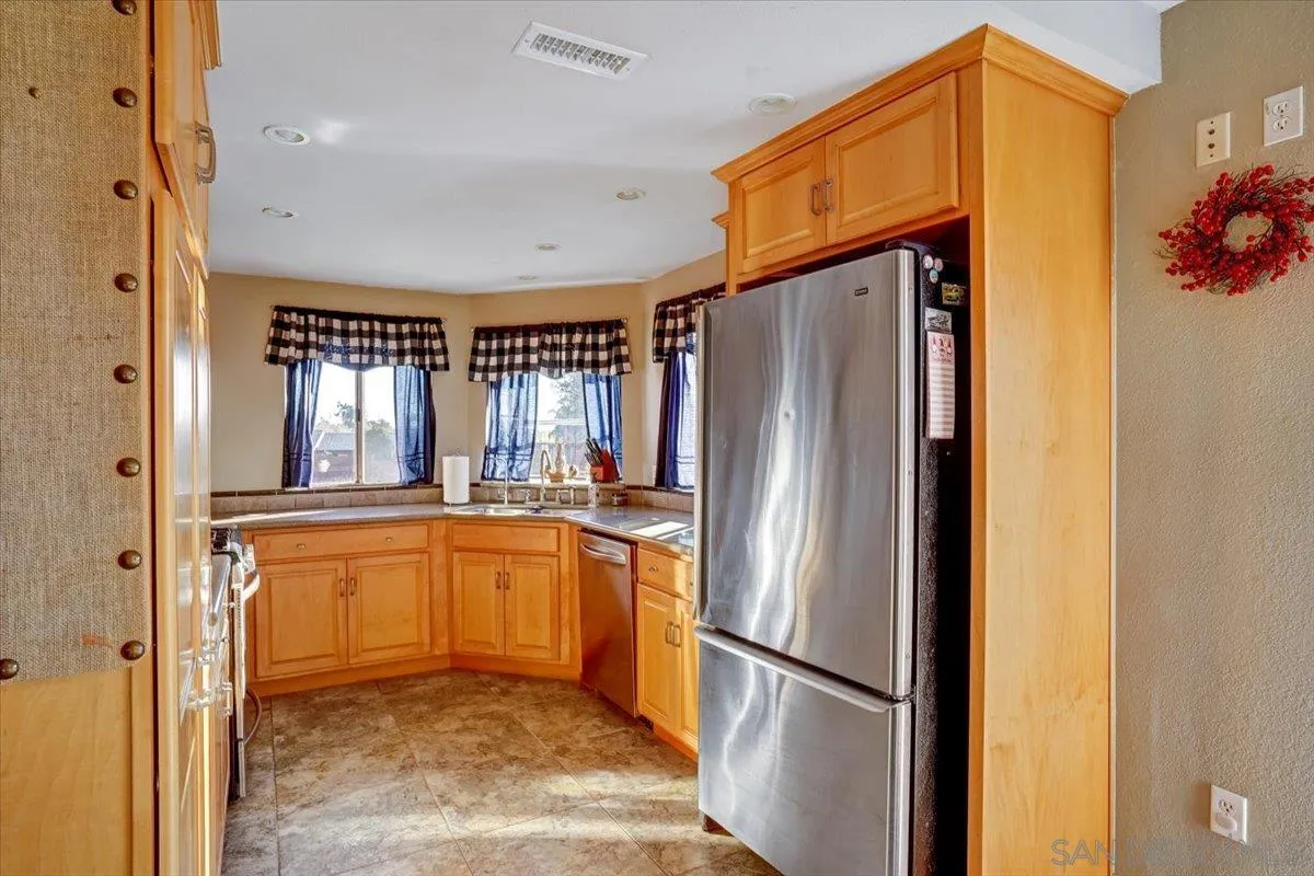 132 Mercedes Road Fallbrook, CA 92028 - Photo 11 of 63 a kitchen with stainless steel appliances granite countertop a refrigerator and a sink
