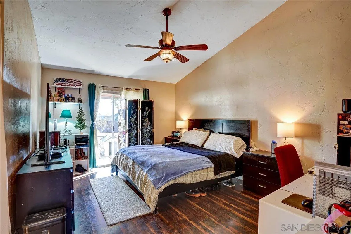 132 Mercedes Road Fallbrook, CA 92028 - Photo 16 of 63 a bedroom with a bed and wooden floor