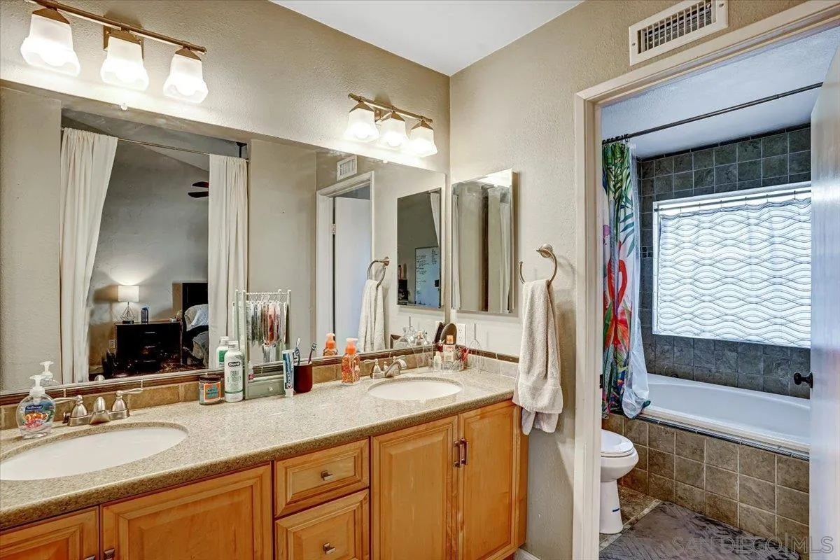 132 Mercedes Road Fallbrook, CA 92028 - Photo 20 of 63 a bathroom with a double vanity sink mirror and toilet