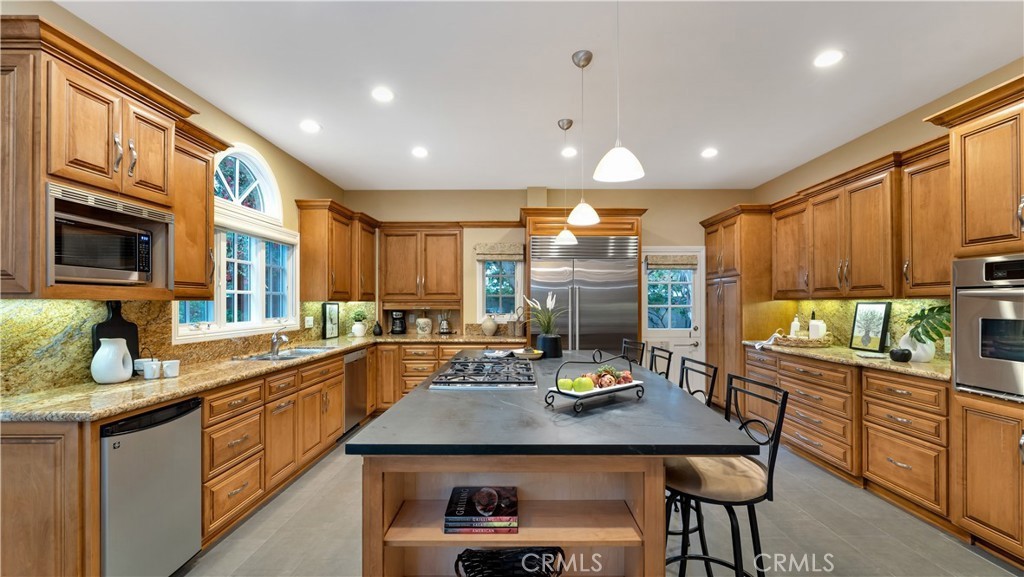 2 Rainstar Irvine, CA 92614 - Photo 13 of 34 a kitchen with stainless steel appliances granite countertop a sink a stove a refrigerator cabinets and living room view