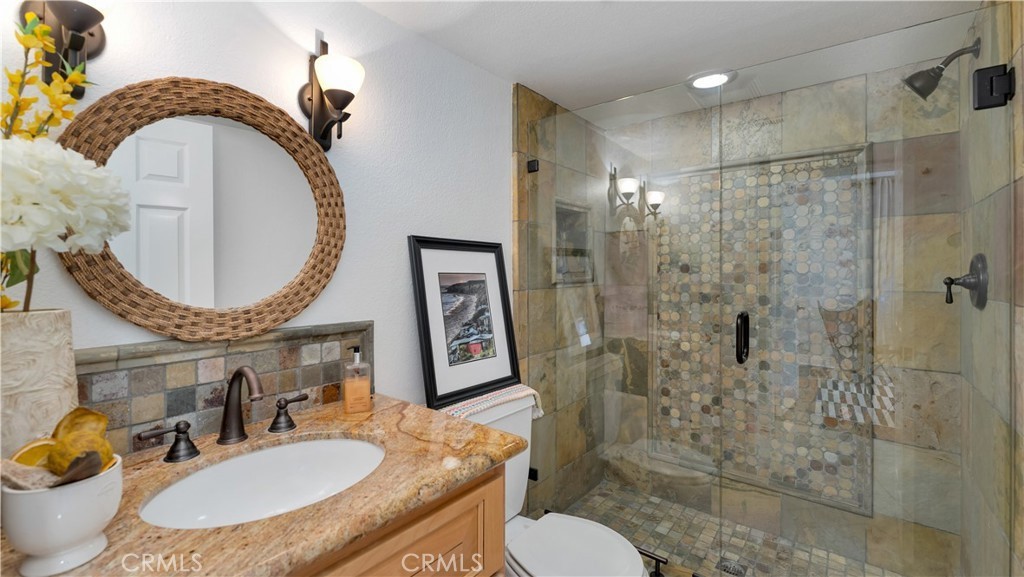 2 Rainstar Irvine, CA 92614 - Photo 18 of 34 a bathroom with a sink toilet a mirror and shower