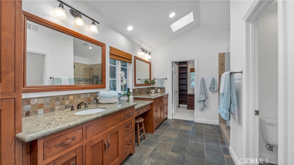 2 Rainstar Irvine, CA 92614 - Photo 24 of 34 a spacious bathroom with a granite countertop sink and a mirror