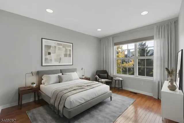 a bedroom with a large bed and a large window