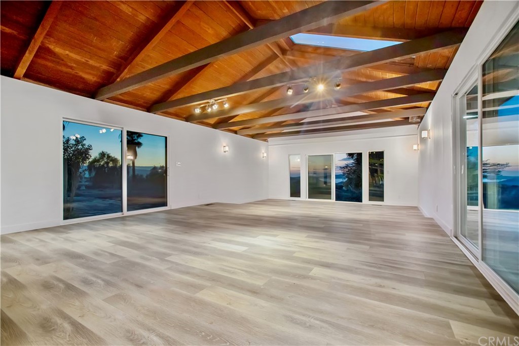 14265 Alva Place Perris, CA 92570 - Photo 13 of 59 a view of an empty room with wooden floor and a window