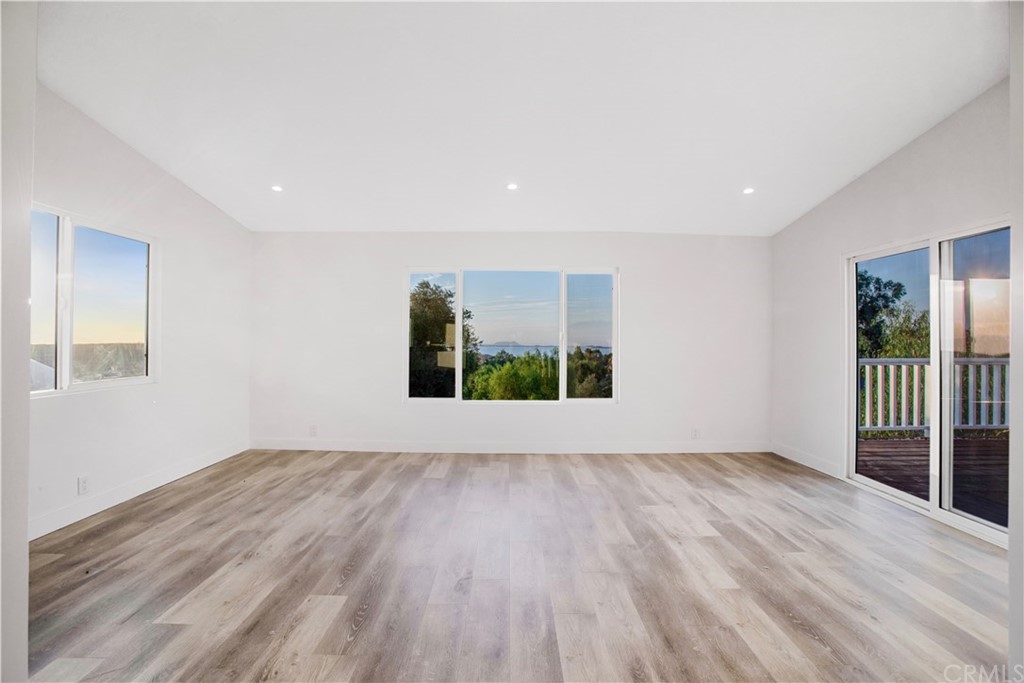 14265 Alva Place Perris, CA 92570 - Photo 28 of 59 a view of an empty room with wooden floor and a window