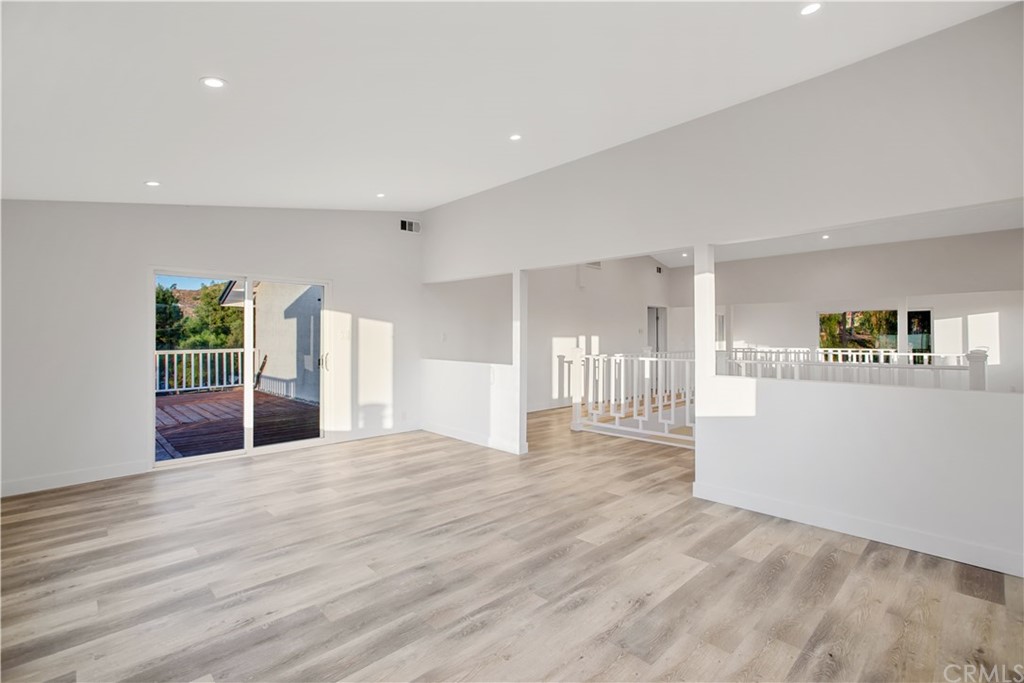 14265 Alva Place Perris, CA 92570 - Photo 29 of 59 a view of an empty room with wooden floor and kitchen