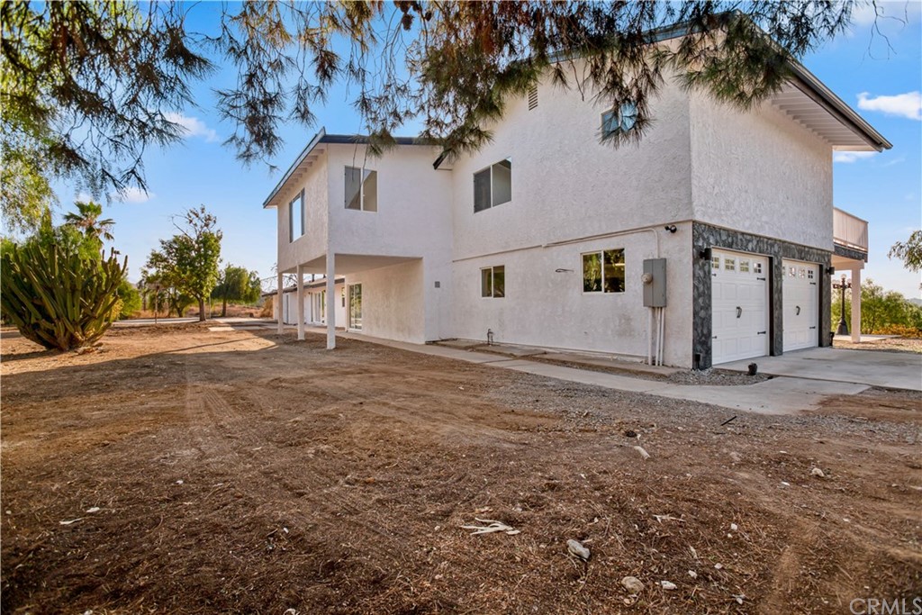 14265 Alva Place Perris, CA 92570 - Photo 49 of 59 a front view of a house with a yard