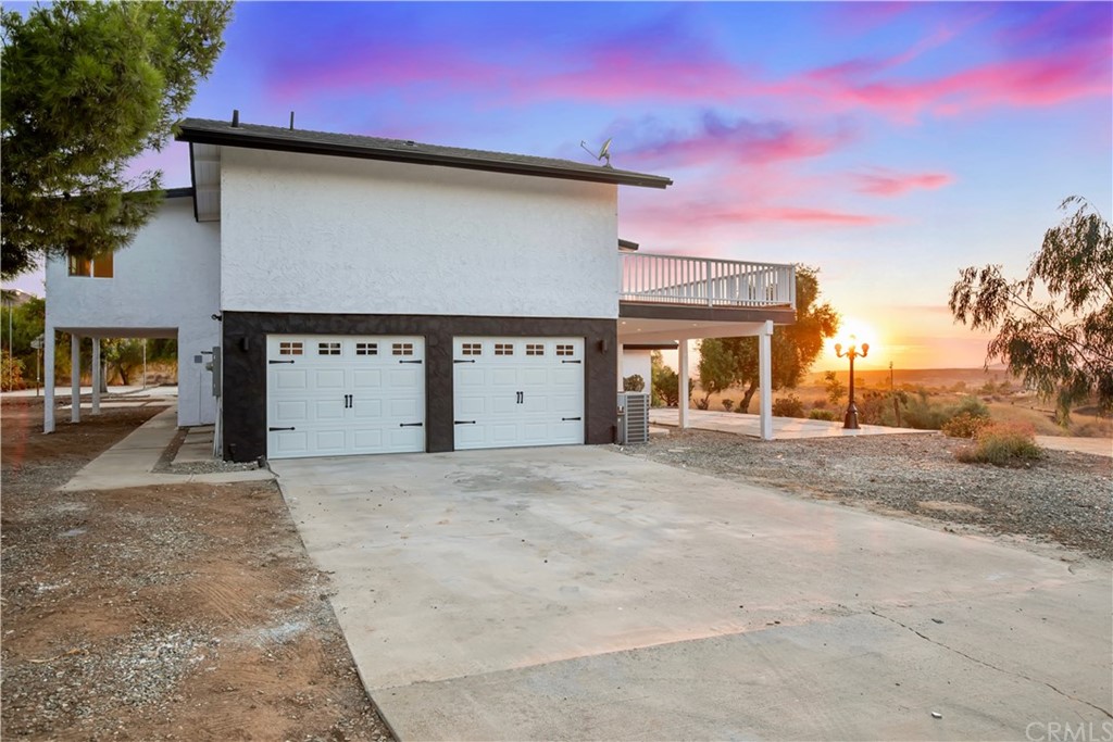 14265 Alva Place Perris, CA 92570 - Photo 50 of 59 a front view of a house with a yard and garage