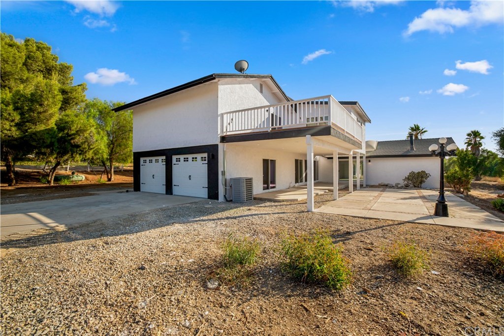 14265 Alva Place Perris, CA 92570 - Photo 5 of 59 a view of a house with a yard and garage
