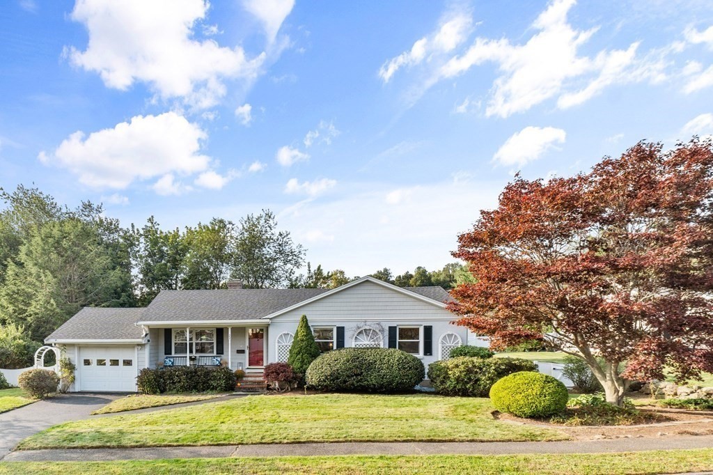 a front view of a house with a garden