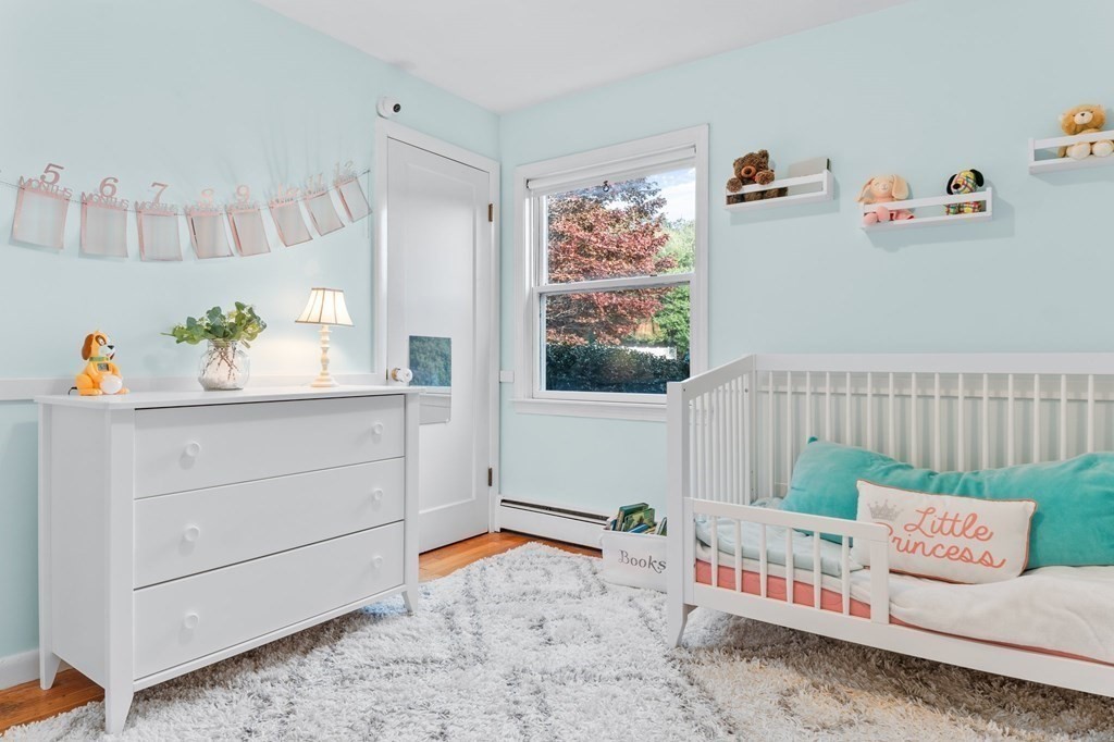22 Bradley Road Danvers, MA 01923 - Photo 17 of 40 a bedroom with furniture and a book shelf