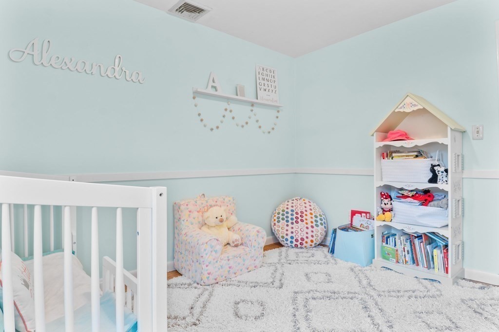 22 Bradley Road Danvers, MA 01923 - Photo 18 of 40 a bedroom with baby bed and baby crib