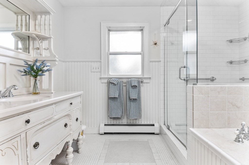 22 Bradley Road Danvers, MA 01923 - Photo 21 of 40 a bathroom with a granite countertop sink a mirror and a shower