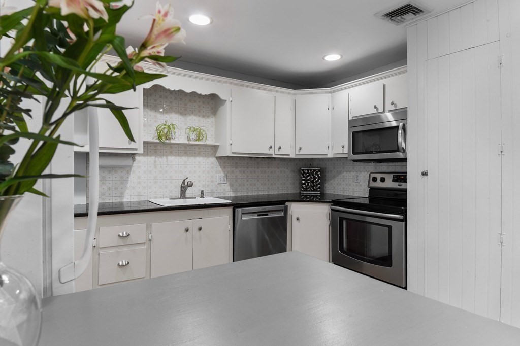 22 Bradley Road Danvers, MA 01923 - Photo 3 of 40 a kitchen with appliances a sink and cabinets
