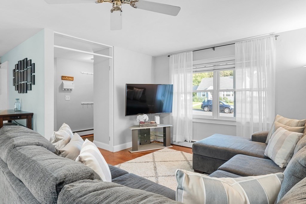 22 Bradley Road Danvers, MA 01923 - Photo 8 of 40 a living room with furniture and a flat screen tv