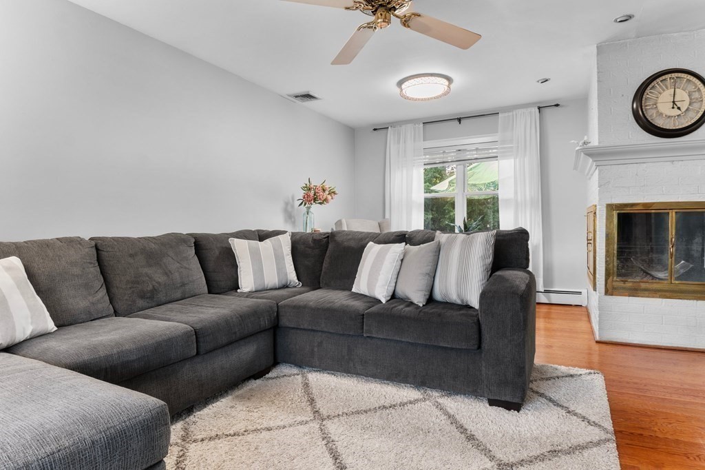 22 Bradley Road Danvers, MA 01923 - Photo 9 of 40 a living room with furniture a fireplace and a window