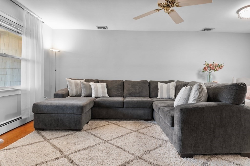 22 Bradley Road Danvers, MA 01923 - Photo 10 of 40 a living room with furniture and a potted plant