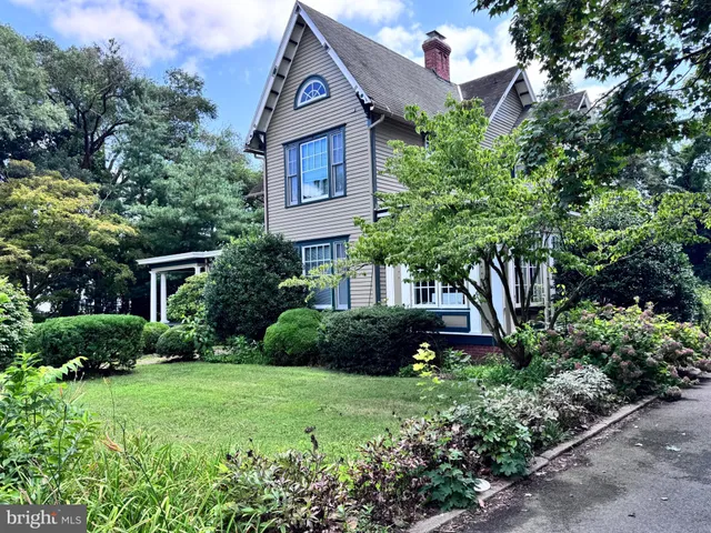 a front view of a house with a yard and plants