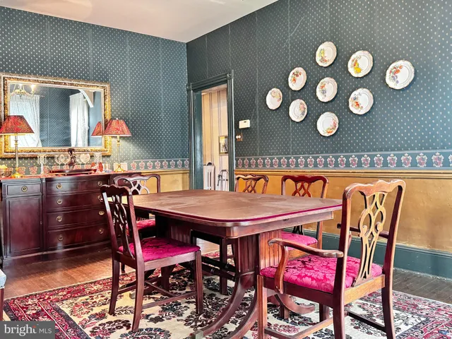 a dinning table sitting in a kitchen next to a blue chair